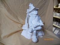 gnome whittling in wood chair